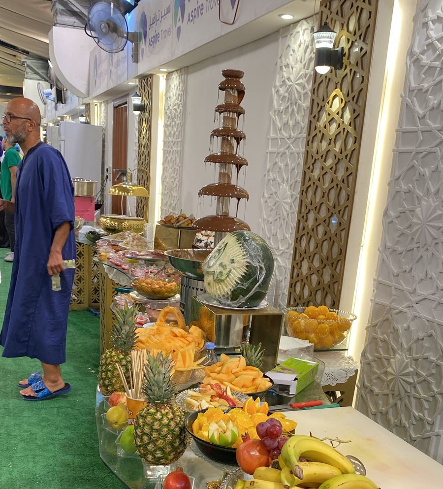 Buffet setup with chocolate fountain and fresh fruits