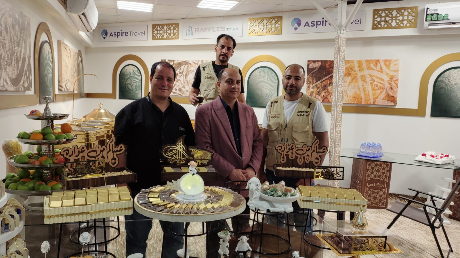 Team photo with staff in uniforms at catering display